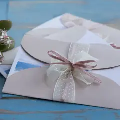 Eleganckie zaproszenia ślubne z kokardkami. Jak odmówić przyjścia na wesele? Delikatne kwiaty dodają uroku.