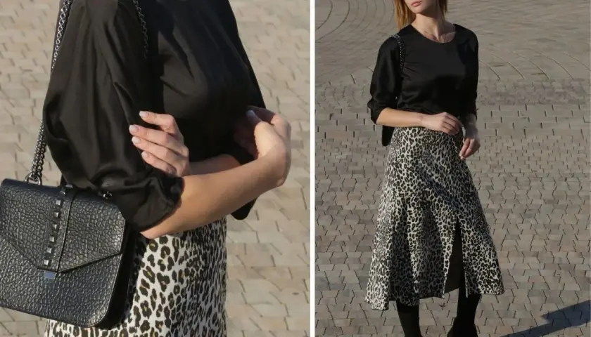 Elegancka czarna bluzka do spódnicy w panterkę, idealna na co dzień i wieczór. Stylizacja z czarną torebką na łańcuszku.