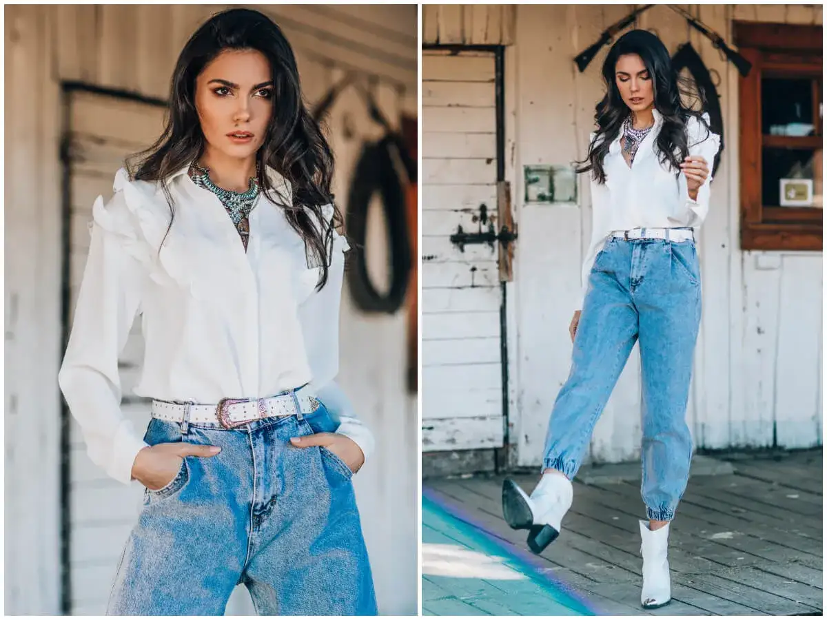 Elegancka biała koszula damska z falbankami i jeansy z wysokim stanem – idealny przykład, jak nosić koszulę damską do spodni w stylu boho-chic.