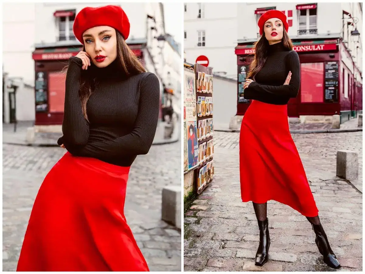 Kobieta w czerwonym beretcie i czarnym golfie, prezentująca power dressing w czerwonej spódnicy, na paryskiej ulicy.